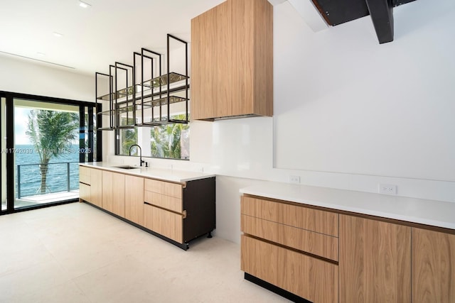 kitchen with modern cabinets, light countertops, and a sink