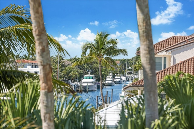 exterior space with a water view, uncovered parking, and a boat dock