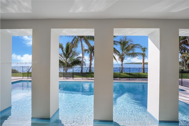 view of swimming pool with a fenced in pool, fence, and a water view