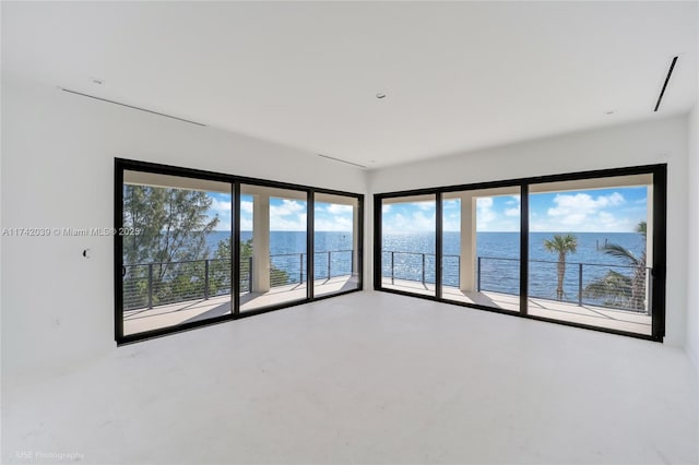 spare room featuring a water view