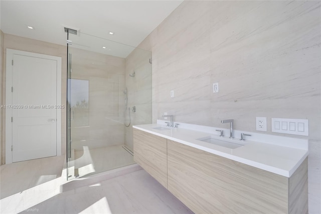 full bathroom featuring a shower stall, tile walls, visible vents, and a sink