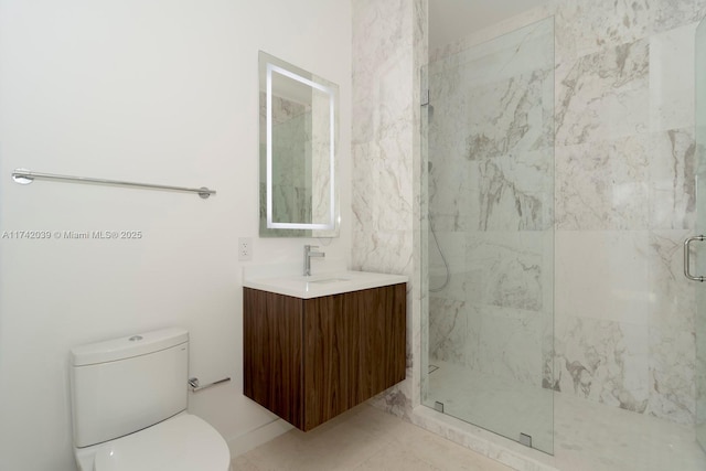 full bath featuring a marble finish shower, toilet, and vanity