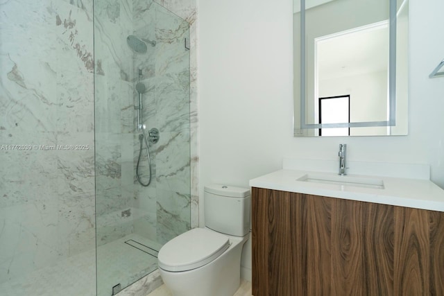 full bathroom with a marble finish shower, toilet, and vanity