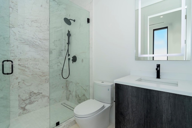 full bath featuring a marble finish shower, toilet, and vanity