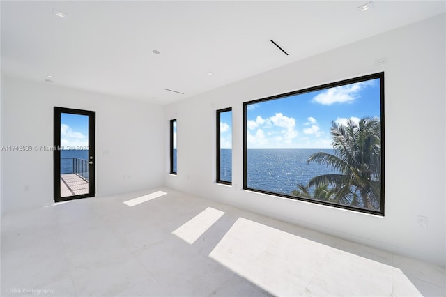 unfurnished room with a water view