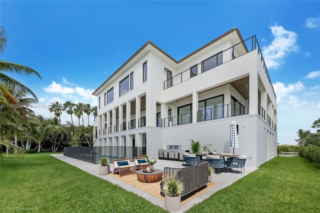 650 Lugo Ave, Coral Gables, FL 33156 - rear view of house featuring a patio area, a balcony, a yard, stucco siding, and an outdoor living space