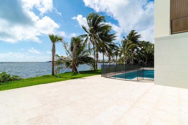 view of swimming pool featuring a patio area and a water view