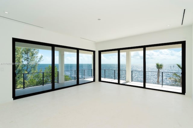 unfurnished room with a water view