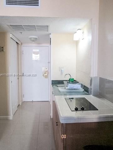 bathroom featuring light tile patterned floors and sink