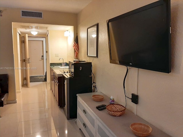 kitchen with sink and light tile patterned floors