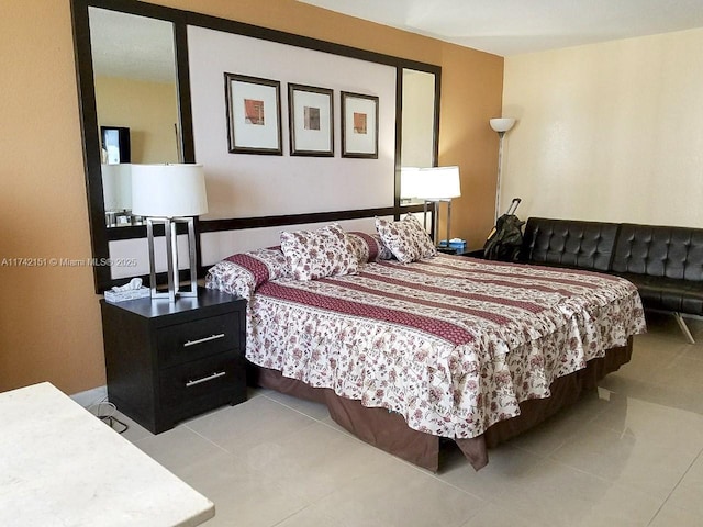 bedroom with light tile patterned floors