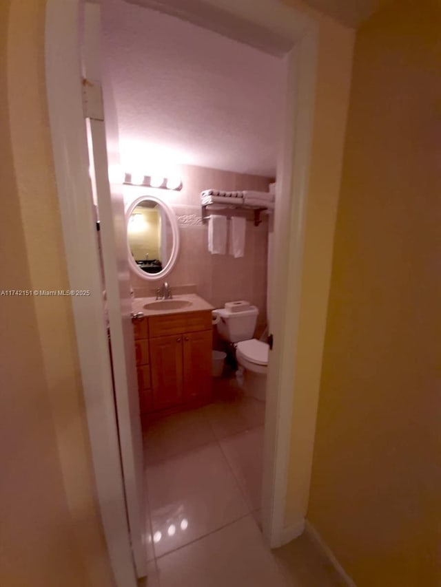 bathroom featuring tile patterned floors, toilet, and vanity