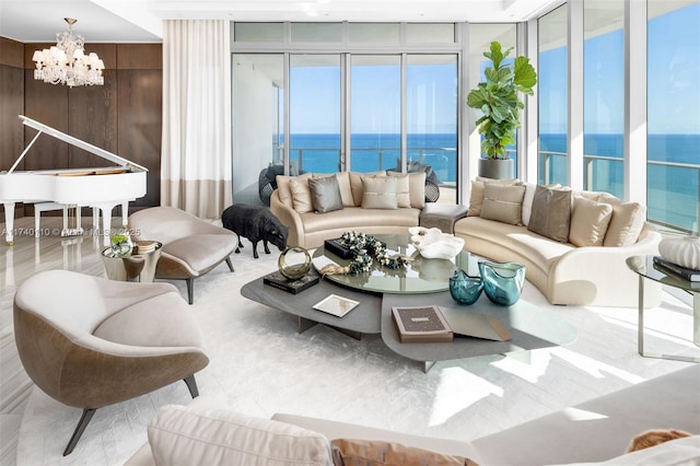 living room with a water view, floor to ceiling windows, and a notable chandelier