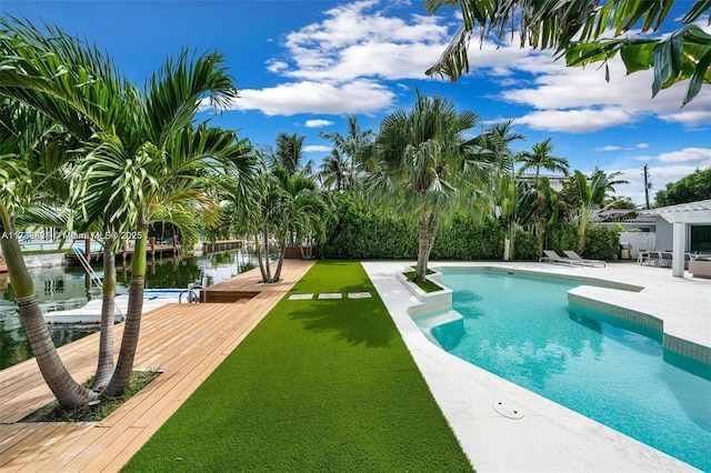 pool featuring a yard and a patio area