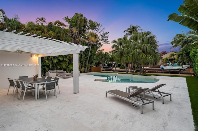 pool at dusk with a patio, an outdoor hangout area, an outdoor pool, outdoor dining space, and a pergola