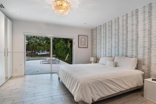 bedroom featuring baseboards, recessed lighting, wood finished floors, and access to outside