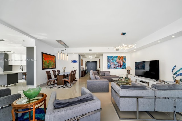 living room with recessed lighting and an inviting chandelier