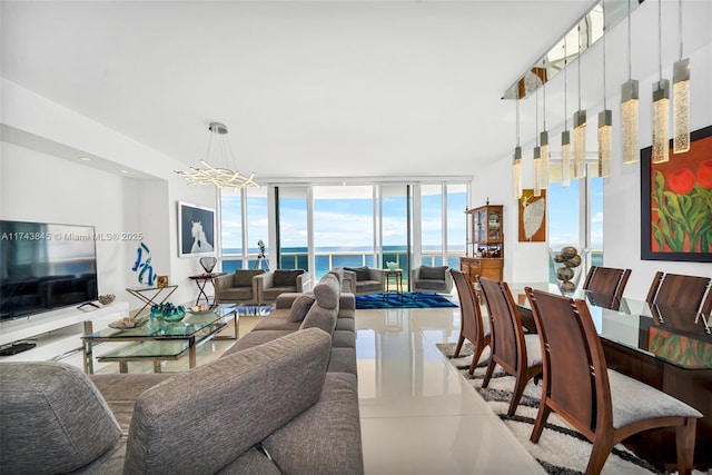 living room featuring a wall of windows and a notable chandelier