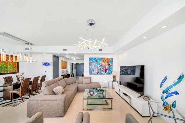 living area featuring recessed lighting, visible vents, and a notable chandelier