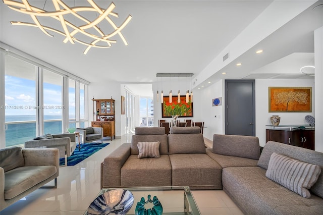 tiled living area with expansive windows, a water view, visible vents, and recessed lighting