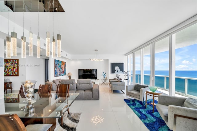 tiled living room featuring expansive windows and an inviting chandelier