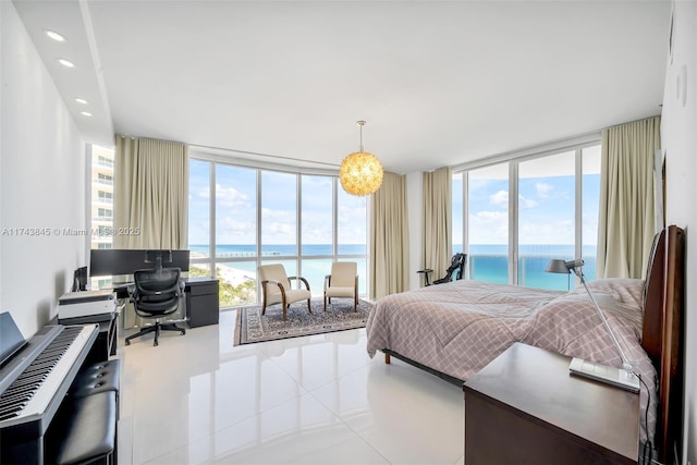 bedroom with recessed lighting, floor to ceiling windows, a water view, and multiple windows