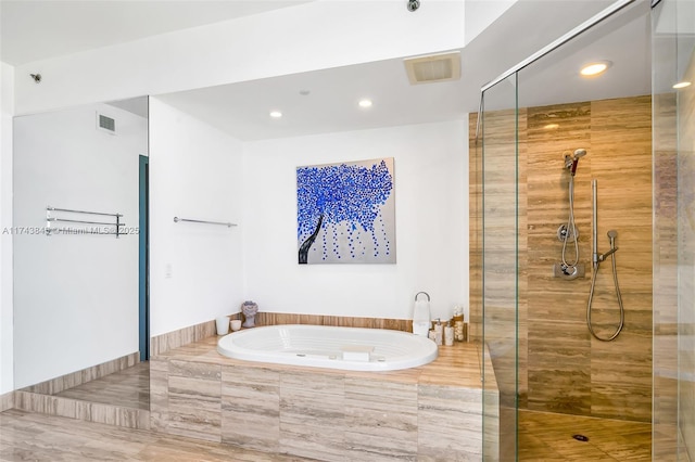 full bathroom with visible vents, a shower stall, and a bath