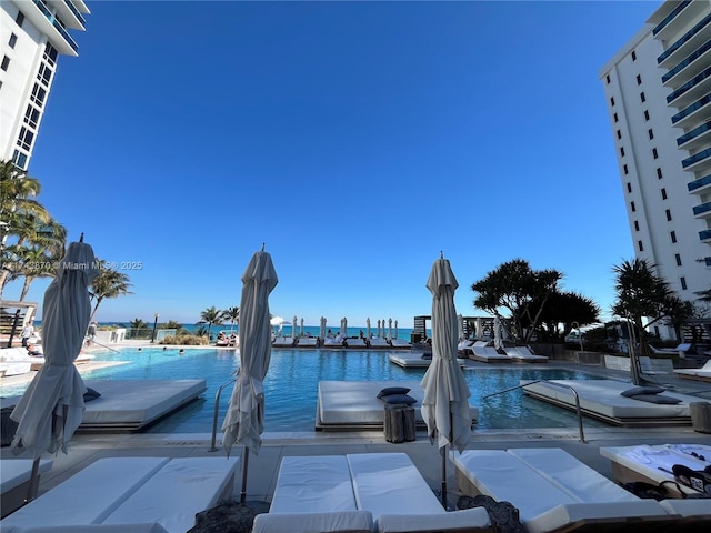 view of dock featuring a water view and a community pool