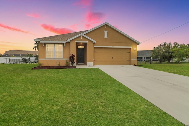 view of front of home with a garage, driveway, a front lawn, and stucco siding