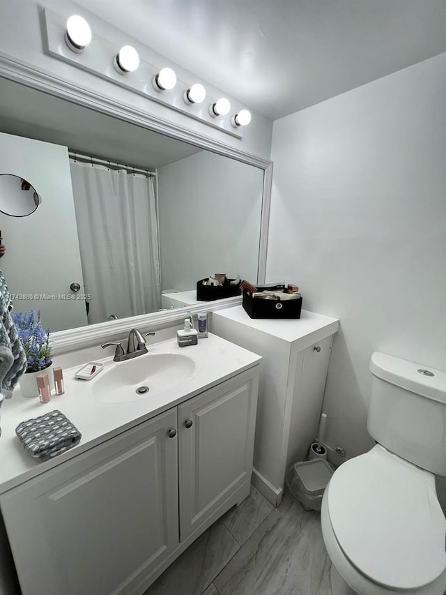 bathroom featuring vanity and toilet