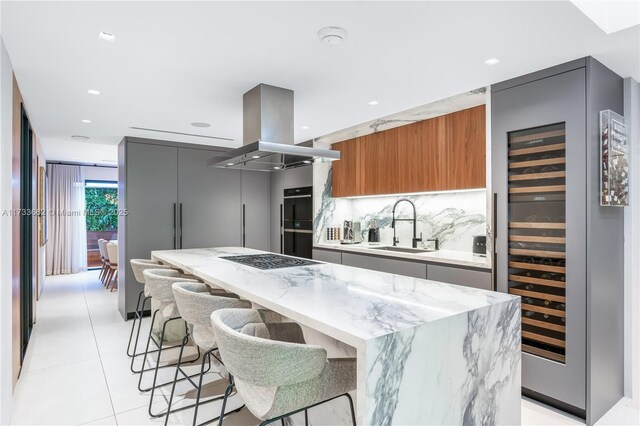 2415 San Domingo St, Coral Gables, FL 33134 - kitchen featuring beverage cooler, a sink, a center island, modern cabinets, and island exhaust hood