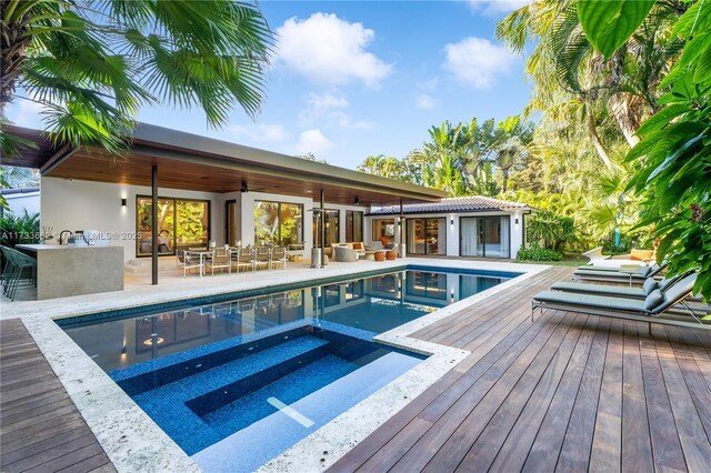 2415 San Domingo St, Coral Gables, FL 33134 - view of swimming pool featuring ceiling fan, an outbuilding, an exterior structure, and a pool with connected hot tub
