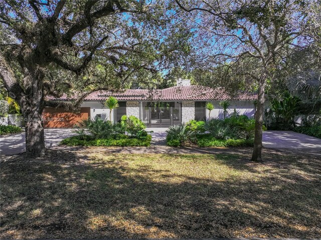 2415 San Domingo St, Coral Gables, FL 33134 - view of front of home featuring a front yard, a tile roof, driveway, and stucco siding