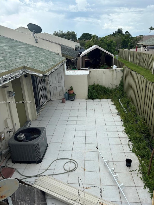 view of patio with central AC unit and a water view