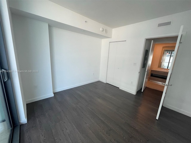 unfurnished room with dark hardwood / wood-style floors