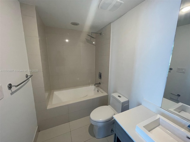 full bathroom with vanity, tiled shower / bath combo, tile patterned floors, and toilet