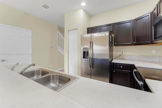 407 SE 32nd Ter, Homestead, FL 33033 - kitchen with appliances with stainless steel finishes, sink, and dark brown cabinets