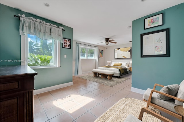 tiled bedroom featuring ceiling fan