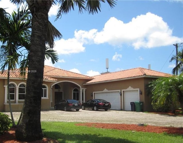 mediterranean / spanish home featuring a garage