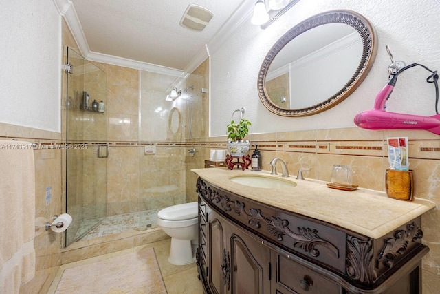 bathroom with crown molding, tile walls, vanity, and toilet