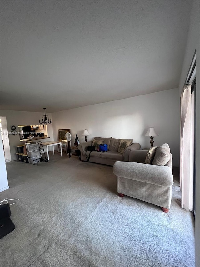 living room with carpet floors and a notable chandelier