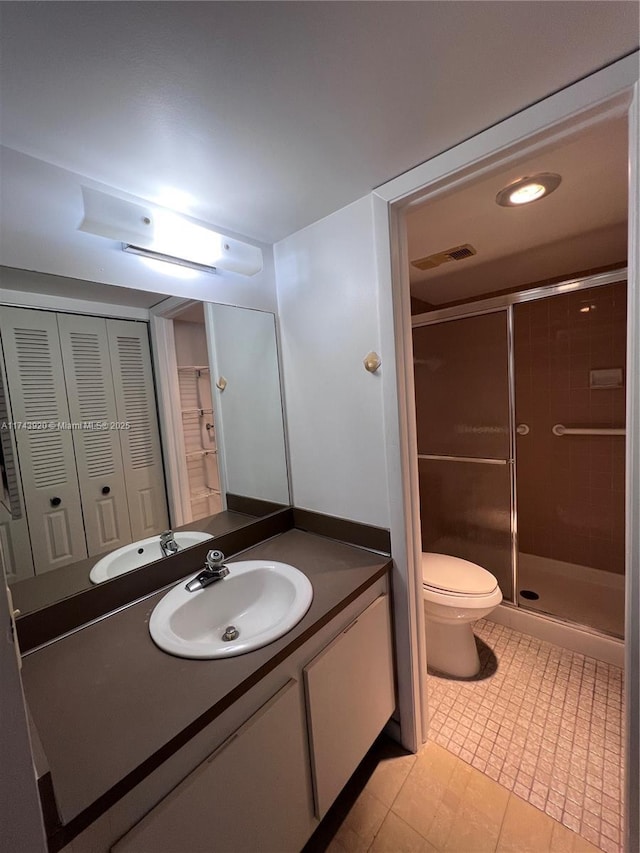 bathroom featuring vanity, toilet, and a shower with door