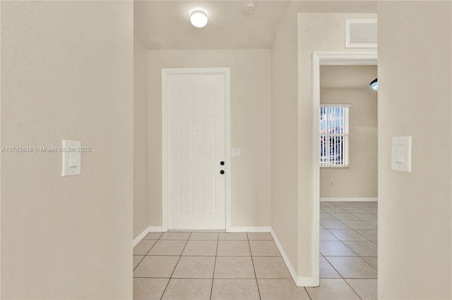 corridor featuring light tile patterned floors