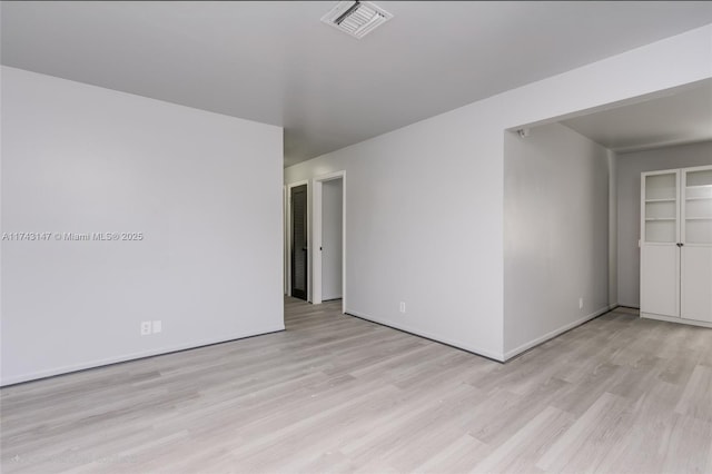 spare room with light hardwood / wood-style flooring