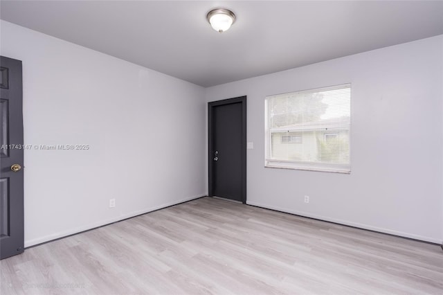 spare room with light hardwood / wood-style floors