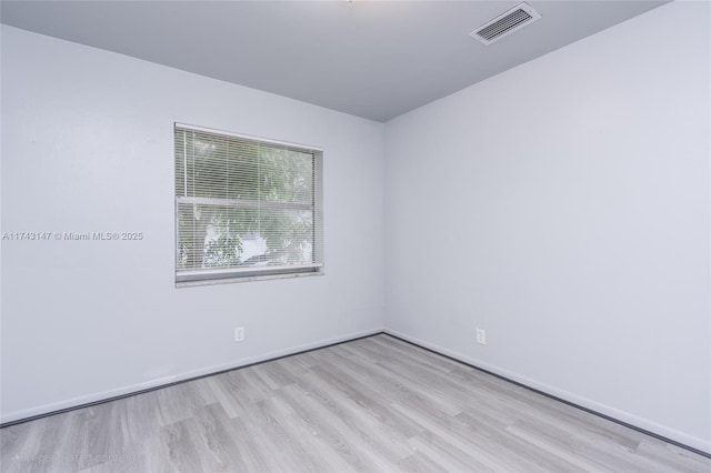 spare room with light wood-type flooring