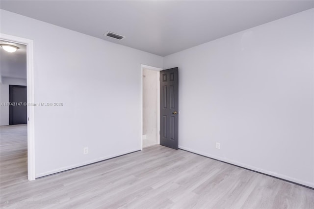 spare room with light hardwood / wood-style flooring