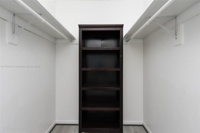 spacious closet with light hardwood / wood-style floors