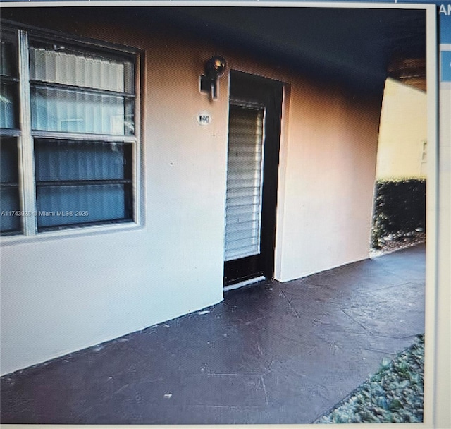 doorway to property with stucco siding