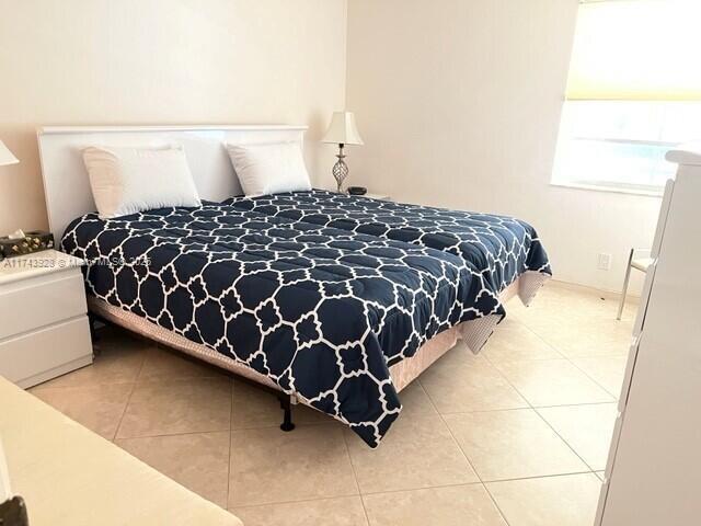 bedroom with light tile patterned floors